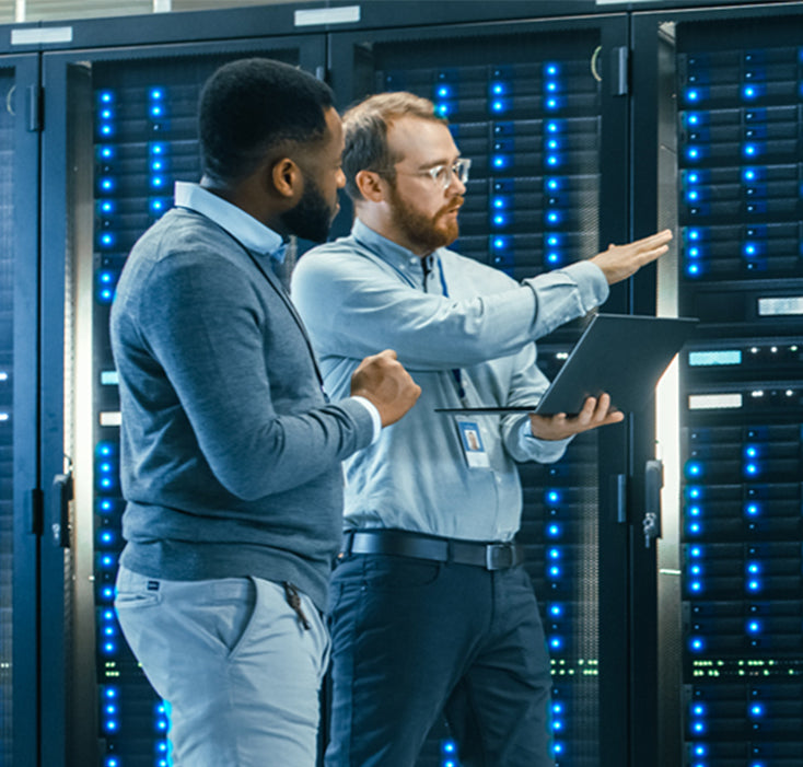 two people in front of computer servers